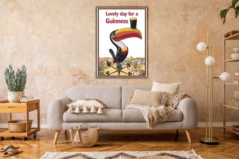 May include: A vintage Guinness advertisement featuring a toucan holding a glass of Guinness with the text "Lovely day for a Guinness".