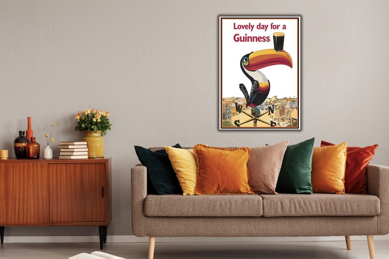 May include: A vintage Guinness advertisement featuring a toucan holding a glass of Guinness with the text "Lovely day for a Guinness".