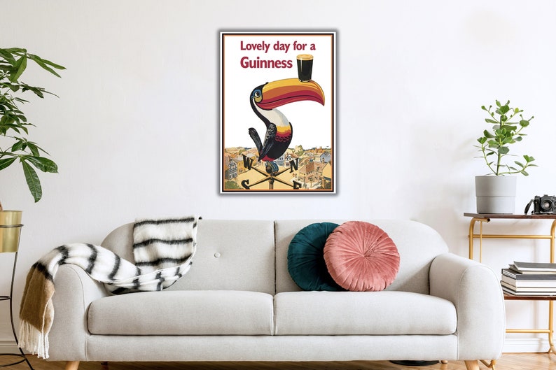 May include: A vintage Guinness advertisement featuring a toucan holding a glass of Guinness with the text "Lovely day for a Guinness".