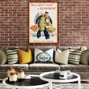 May include: A vintage Guinness advertisement poster featuring a sailor carrying a large amount of fruit and vegetables. The poster has the text "Now, I feel I need a GUINNESS" and "GUINNESS FOR STRENGTH".
