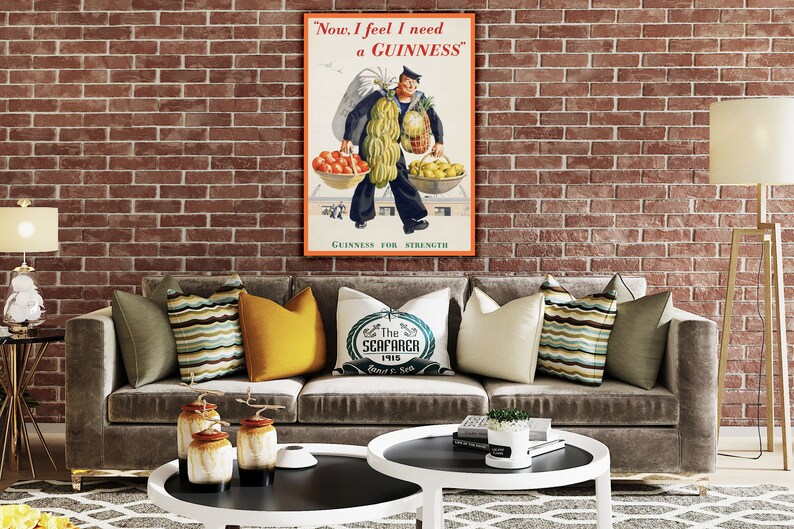May include: A vintage Guinness advertisement poster featuring a sailor carrying a large amount of fruit and vegetables. The poster has the text "Now, I feel I need a GUINNESS" and "GUINNESS FOR STRENGTH".