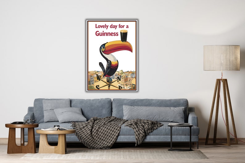 May include: A vintage Guinness advertisement featuring a toucan holding a glass of Guinness with the text "Lovely day for a Guinness".
