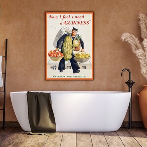 May include: Vintage Guinness advertisement featuring a man carrying a large amount of fruit and vegetables. The text reads "Now, I feel I need a GUINNESS." and "GUINNESS FOR STRENGTH."