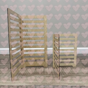 May include: Three wooden display stands with horizontal slats. The largest stand is a folding screen, and the other two are smaller, rectangular boxes. The stands are made of light-colored wood and are set against a patterned background.