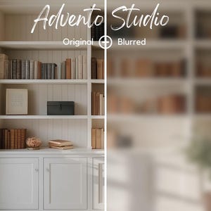 May include: A white bookshelf with three shelves filled with books. The top shelf has a framed picture and a small black box. The middle shelf has a stack of books and a small decorative object. The bottom shelf has a stack of books. The bookshelf is in a room with a window and white walls.