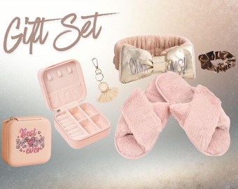 May include: A gift set featuring a pink jewelry box with the text "Best Mom Ever", a gold bow headband with "OMG!" text, a pair of pink fuzzy slippers, a gold scrunchie, and a keychain with a tassel.