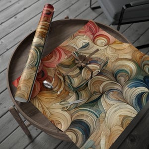 May include: A roll of colorful wrapping paper with a swirling pattern in shades of brown, red, blue, and green. The paper is on a wooden table with a small gift box wrapped in the same paper.