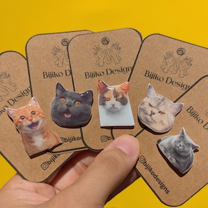 May include: Five different cat pin designs on brown cards with the text "Bijiko Design" on each card. The cat pins are all different breeds and have different expressions.