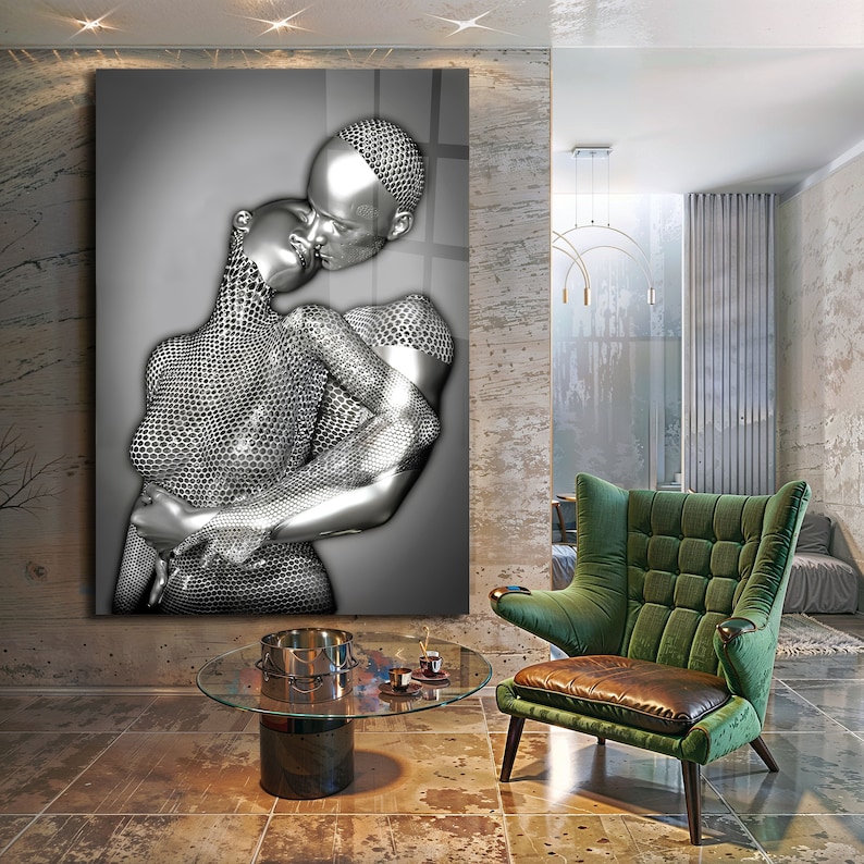 May include: A black and white photograph of a couple embracing. The couple is depicted in a silver, metallic, textured style. The image is printed on a canvas and framed.