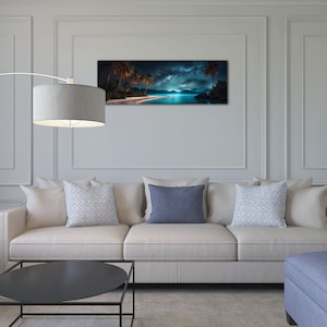 May include: A living room interior design featuring a white sofa with three cushions, a black coffee table, a blue footstool with a throw blanket, and a floor lamp with a grey shade. A panoramic photograph of a tropical beach scene with palm trees and a starry night sky hangs on the wall.