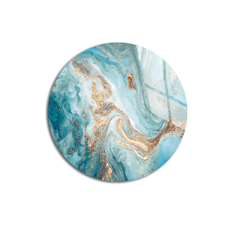 May include: Abstract round art print with swirling blue and white paint with gold glitter accents.