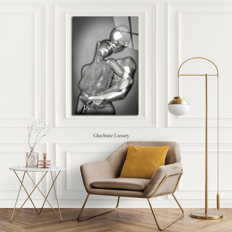 May include: A black and white photograph of a couple embracing. The couple is depicted as a silver, metallic sculpture. The image is printed on a glass panel with the text "GlassState Luxury" printed below the image.