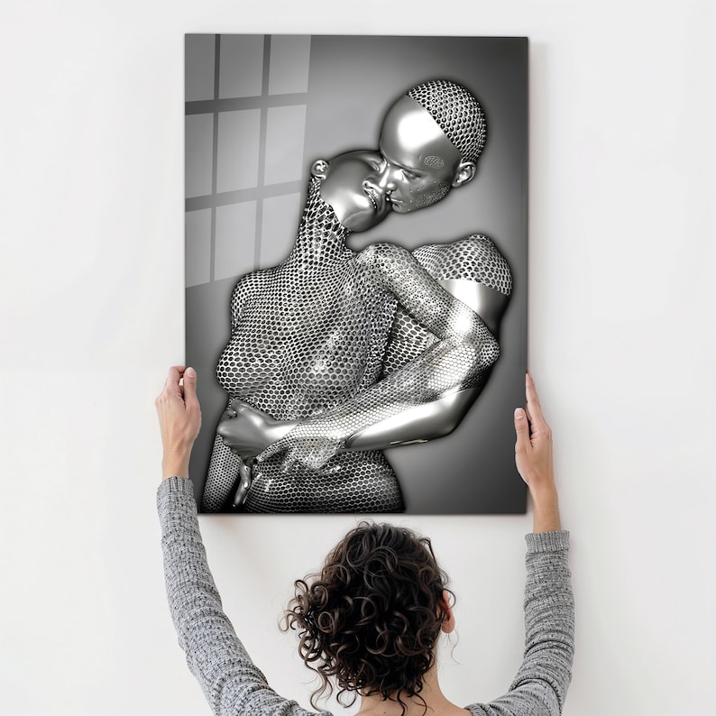 May include: A black and white abstract art print of two figures in a romantic embrace. The figures are made of a metallic material with a textured surface.