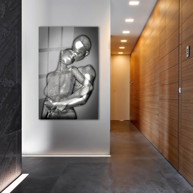 May include: A black and white photograph of a couple embracing. The couple is depicted in a silver, metallic, geometric pattern. The image is printed on a canvas.