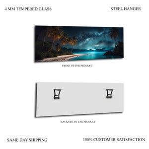 May include: A panoramic photograph of a tropical beach at night with palm trees, a starry sky, and a moonlit ocean. The image is printed on a 4 mm tempered glass panel with a steel hanger on the back.
