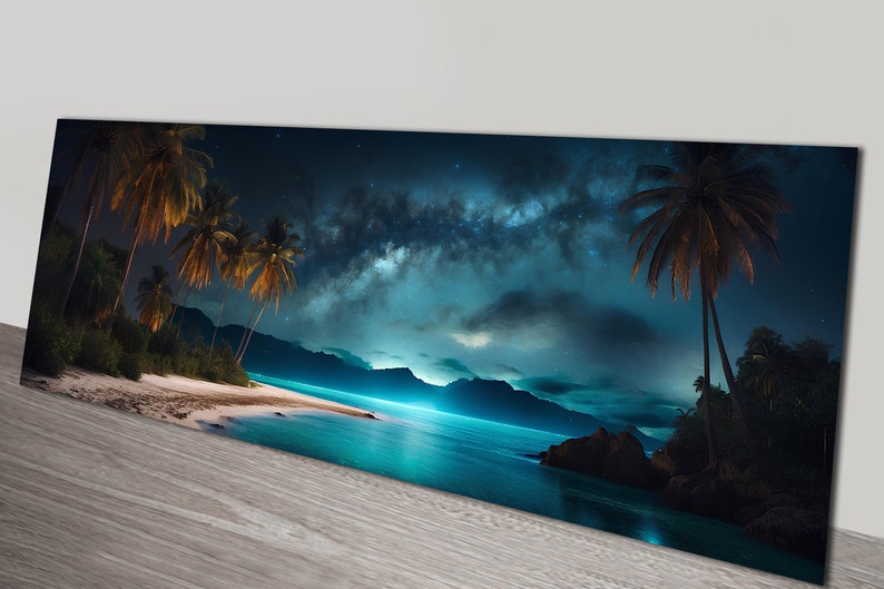 May include: A panoramic view of a tropical beach at night with palm trees silhouetted against a dark blue sky. The Milky Way galaxy is visible in the sky, with a bright blue glow reflecting off the water.