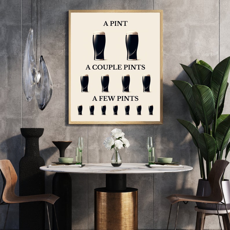 May include: A framed print featuring the text "A Pint, A Couple Pints, A Few Pints" with illustrations of stout glasses. The print is in a light wood frame. The image is part of a dining room setting with a marble table.