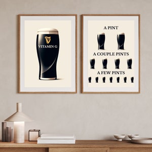 May include: Two framed prints with wooden frames. One print shows a pint of dark beer with the text "Vitamin G" and a gold harp logo. The other print shows the progression of beer consumption: "A Pint", "A Couple Pints", and "A Few Pints".
