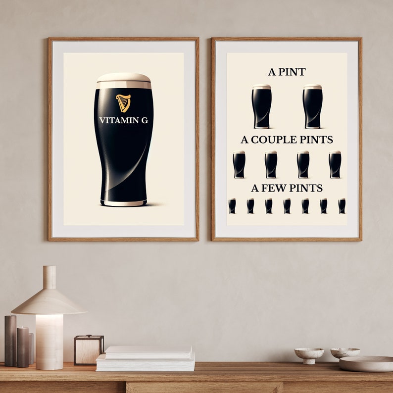 May include: Two framed prints with wooden frames. One print shows a pint of dark beer with the text "Vitamin G" and a gold harp logo. The other print shows the progression of beer consumption: "A Pint", "A Couple Pints", and "A Few Pints".