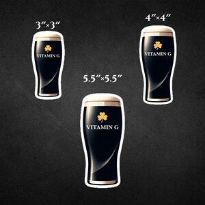 May include: Three sticker sizes are shown: 3"x3", 4"x4", and 5.5"x5.5". Each sticker depicts a dark stout beer with a white foamy head, a gold shamrock, and the text "VITAMIN G". The stickers have a white border.