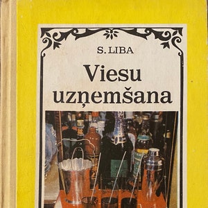 May include: A yellow book with a black and white illustration of a bar scene. The book's title is "Viesu uznemšana" in black text.