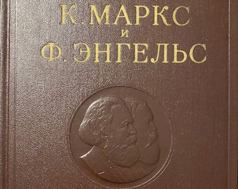 May include: A brown book with gold lettering on the cover. The title reads "K. MARX and F. ENGELS". The cover features a circular embossed image of two men's faces.