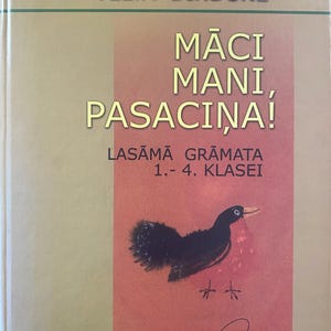 May include: A book cover with the title "Māci Mani, Pasaciņa!" by Velta Dindone. The cover features a black bird illustration on a red background, with text in Latvian. The book is for grades 1-4.