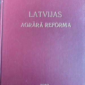 May include: A burgundy book with the title "LATVIJAS AGRĀRĀ REFORMA" and the year "1930" printed on the front cover.