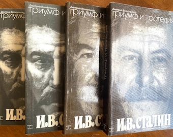 May include: Four hardcover books with black covers and white text. The books are titled "Triumph" and "Triumph and Tragedy." The author is listed as Dmitry Volkogonov. The books feature a black and white portrait of Joseph Stalin on the cover.
