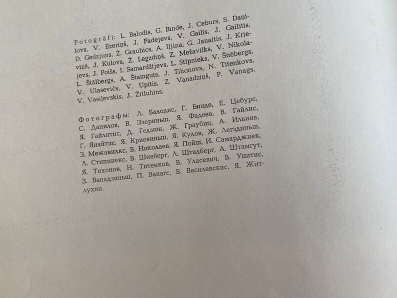 May include: A list of names in both English and Latvian, likely a list of photographers. The list is printed in black ink on a white background.