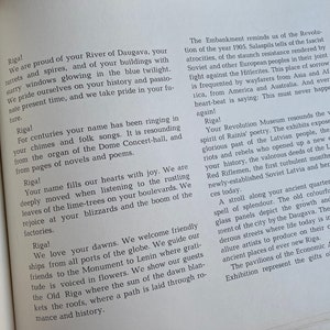 May include: A book with a white cover and black text. The text on the cover reads "Riga!" and describes the city of Riga, Latvia. The text includes details about the city's history, culture, and landmarks.