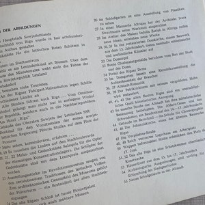 May include: A black and white page from a book with the title "VERZEICHNIS DER ABBILDUNGEN" and a numbered list of descriptions of images. The list includes the city of Riga, Latvia, and its landmarks.