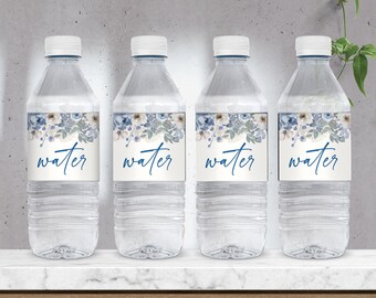 May include: Four clear plastic water bottles with blue and white floral labels that say "water" in blue script.