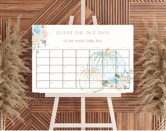 May include: A white printable sign with a blue and white floral design and the text "Guess the Due Date of our sweet baby boy". The sign features a calendar with a blue and white pumpkin design.