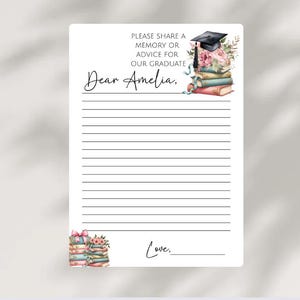 May include: A white graduation advice card with lined pages. The card features the text "PLEASE SHARE A MEMORY OR ADVICE FOR OUR GRADUATE" and "Dear Amelia," in elegant script. Floral and book illustrations adorn the card.