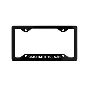 May include: Black license plate frame with the text "CATCH ME IF YOU CAN" in white. The frame has a rectangular shape with rounded corners and mounting holes. The text is centered at the bottom.
