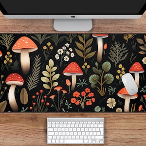 May include: A black and white mousepad with a repeating pattern of red and white mushrooms and green foliage. The mousepad is 31 inches by 15.5 inches.