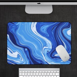 May include: Blue and white abstract marble design mouse pad. The design features swirling blue and white lines.