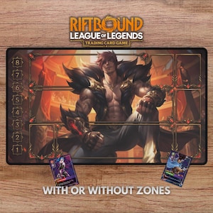 May include: A rectangular Riftbound League of Legends Trading Card Game playmat. The mat features a muscular character illustration with a red and gold color scheme. Two trading cards are visible, and the text "WITH OR WITHOUT ZONES" is printed at the bottom.
