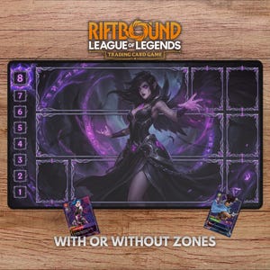 May include: A black Riftbound League of Legends trading card game playmat with a purple and black illustration of a female character. The mat has zones for card placement and the text "WITH OR WITHOUT ZONES".