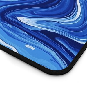May include: Blue and white abstract marble pattern laptop sleeve with a black zipper.