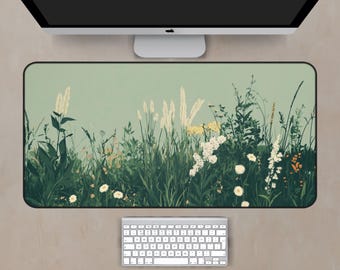 May include: A green and white floral design mouse mat with a soft, textured surface. The design features a variety of flowers and grasses in a field.