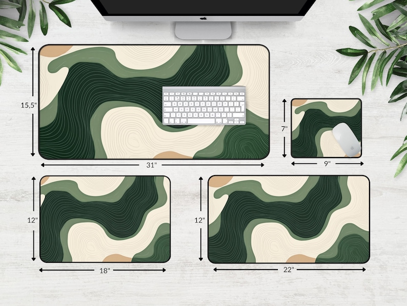 May include: A set of four desk mats featuring an abstract design in green, beige, and brown. The largest mat is 78.7 cm long and 39.4 cm wide, with a keyboard on top. A mouse pad and two smaller mats are also included.