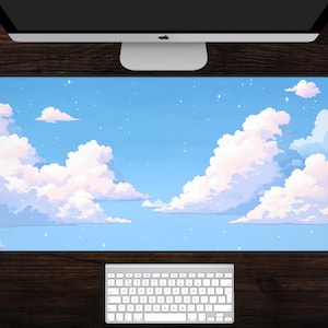 May include: A rectangular desk mat featuring a pixelated sky scene with fluffy white clouds against a light blue backdrop. The mat is shown with a computer monitor and keyboard, suggesting a workspace accessory.