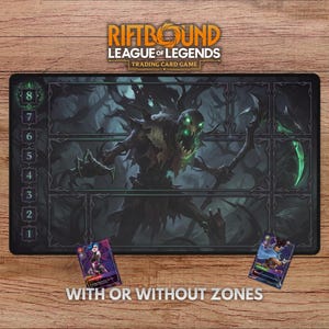 May include: A black Riftbound League of Legends trading card game playmat with a dark fantasy illustration and numbered zones. Two trading cards are placed on the wooden surface. The text "WITH OR WITHOUT ZONES" is at the bottom.