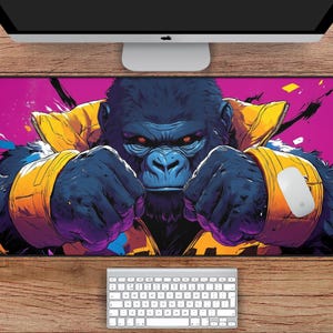 May include: A large, colourful mouse mat featuring a close-up of a gorilla's face. The gorilla is wearing a yellow and purple jacket and has a serious expression. The background is a vibrant pink and purple.