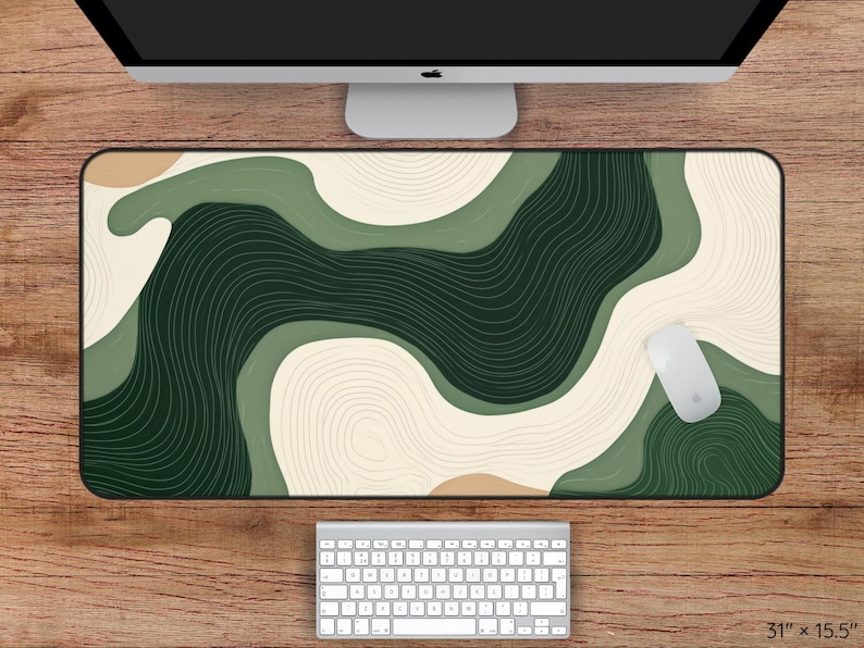 May include: A large rectangular desk mat with an abstract design in green, beige, and tan. The mat measures 78.7 cm by 39.4 cm. A white mouse and keyboard are visible.