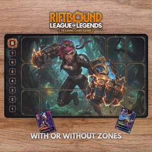 May include: A Riftbound League of Legends trading card game playmat featuring a character with pink hair and mechanical gauntlets. The mat has numbered zones and includes two trading cards. The text "WITH OR WITHOUT ZONES" is at the bottom.