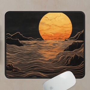May include: A black and gold mouse pad with a stylized illustration of a large orange sun setting over a wavy ocean. The ocean is depicted with thin, wavy lines.