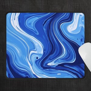 May include: Blue and white abstract marble design mouse pad. The mouse pad is 9 inches by 7 inches.
